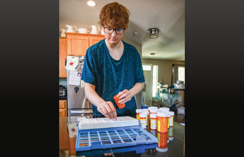 Battle Ground High School class of 2026 graduate Jackota Salmi fills his daily medication on Wednesday, July 8, after receiving a life-saving kidney transplant near the end of June.