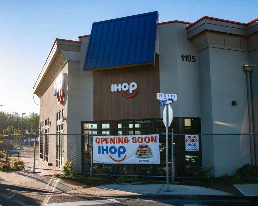 An "Opening Soon" banner and hiring sign hang outside the future IHOP at 1105 SW Scotton Way on Friday, July 31.