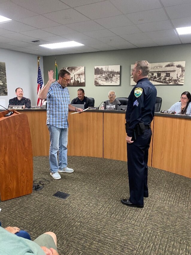 Woodland Police Sgt. Trevor Eades is sworn in by Mayor Todd Dinehart before Woodland City Council during a Monday, Aug. 3, meeting.