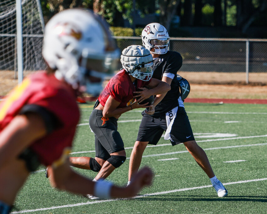 Prairie Falcons football players run a play during practice on Tuesday, Aug. 25.