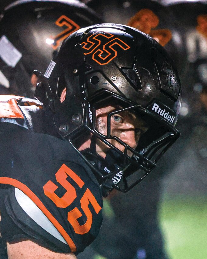Battle Ground center Turner Avery looks across the line before snapping the ball during the Tigers&rsquo; 24-17 win over the Ridgefield Spudders on Friday, Sept. 4.