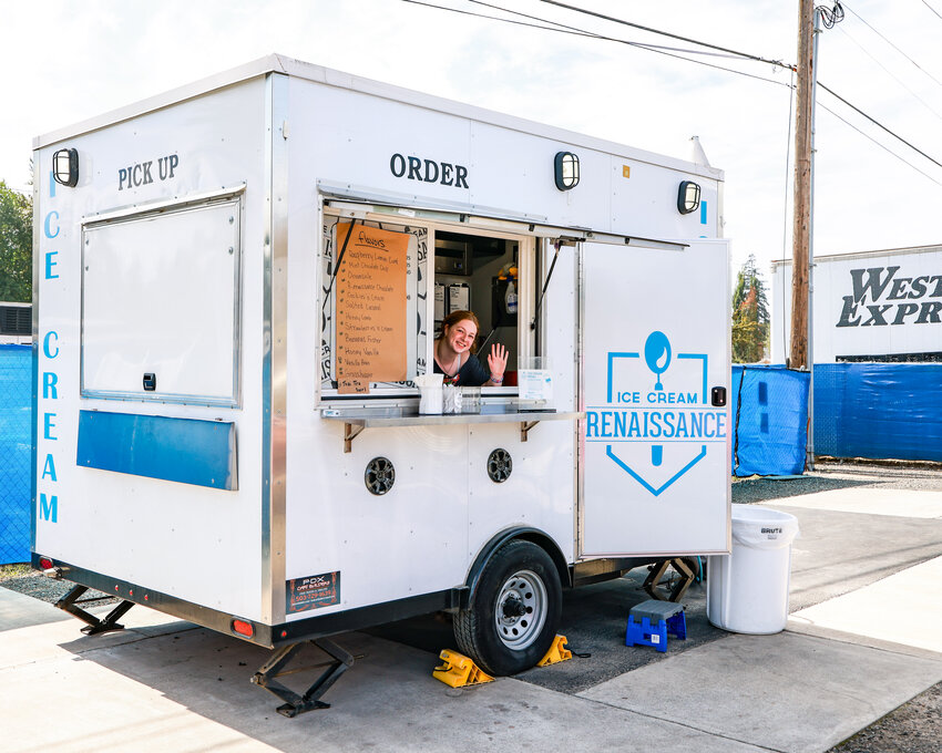 Ice Cream Renaissance food cart server Alex Green waves from within the cart parked behind Founder&rsquo;s Mercantile and Coffee on Thursday, Sept. 10.