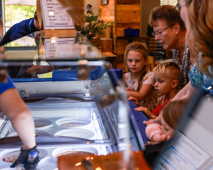 Kids look at the ice cream offerings at Exit 16 Sips and Scoops in La Center, which opened on Thursday, Sept. 10.
