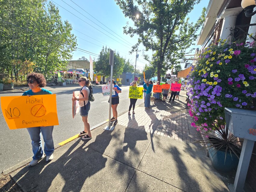 Sign wavers oppose the current development plans during a Sept. 9 rally in downtown Ridgefield.