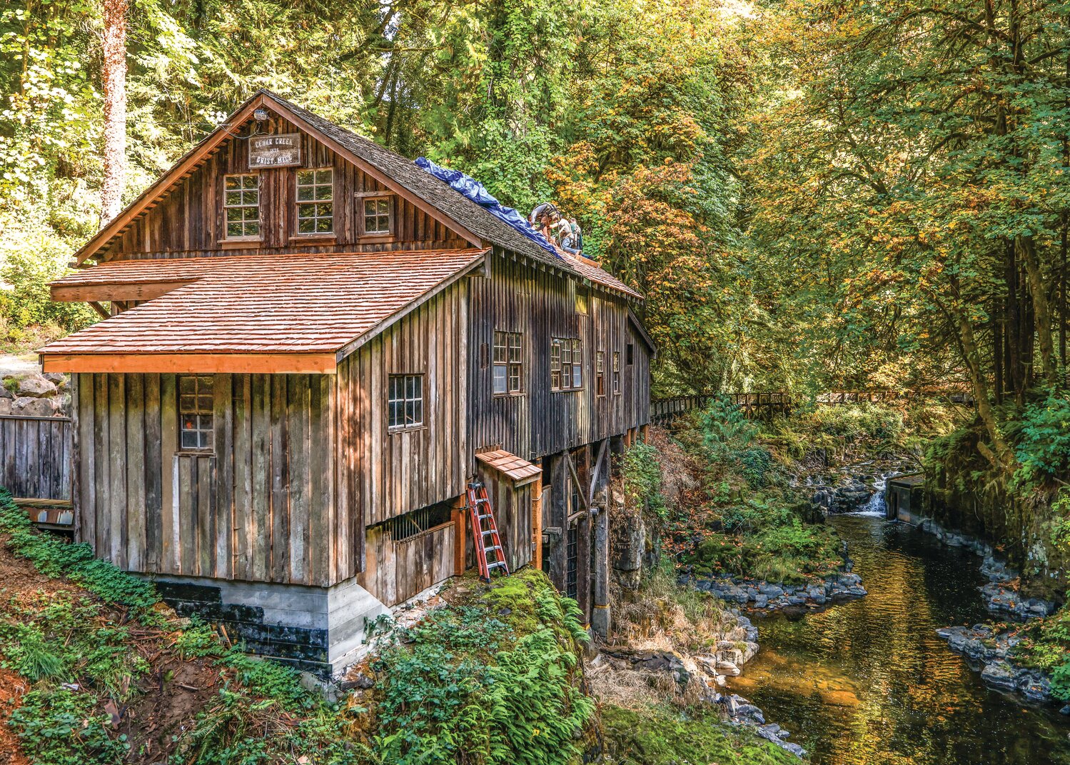 Contract crews work to replace historically-accurate cedar shake roofing at the Cedar Creek Grist Mill on Thursday, Oct. 8.